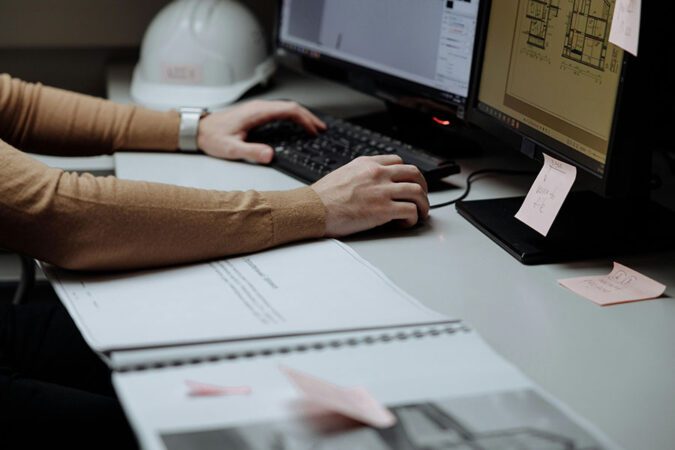 A close-up photo of a person using construction software on a computer