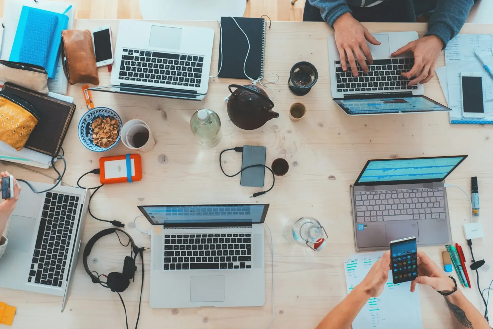 People using smartphones and laptops at work