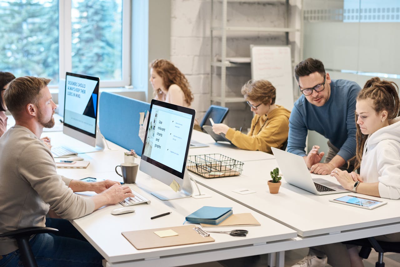 People in an office space working with computers