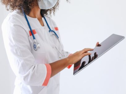 Female doctor reviewing patient data on a tablet computer