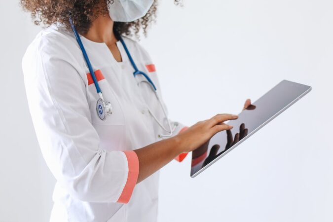 Female doctor reviewing patient data on a tablet computer