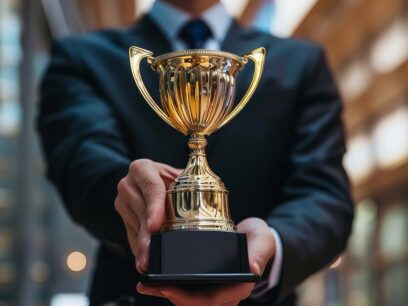 Closeup of businessman holding a trophy