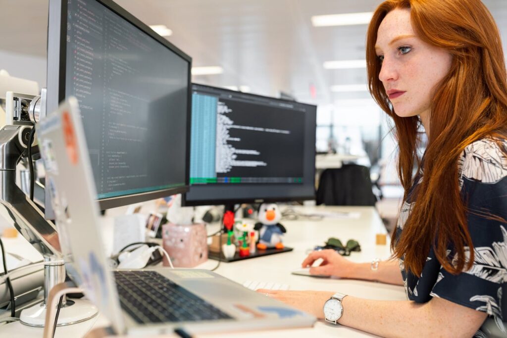 A lady coding on a computer