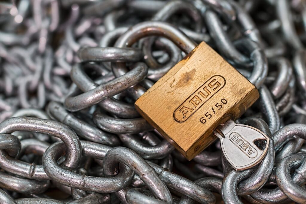 An padlock locked around chain links symbolizing data security